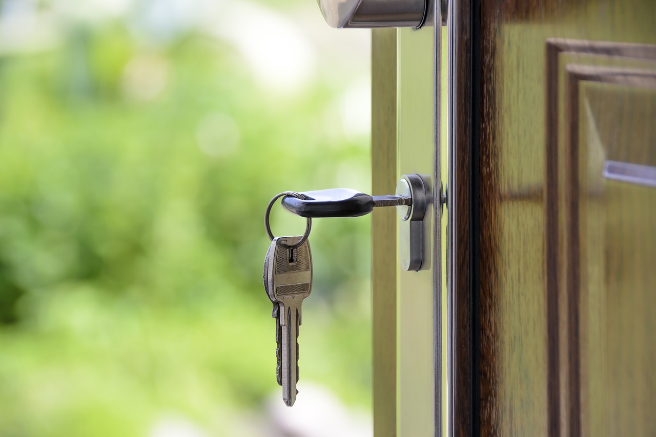 Keys in the door of a well-kept home